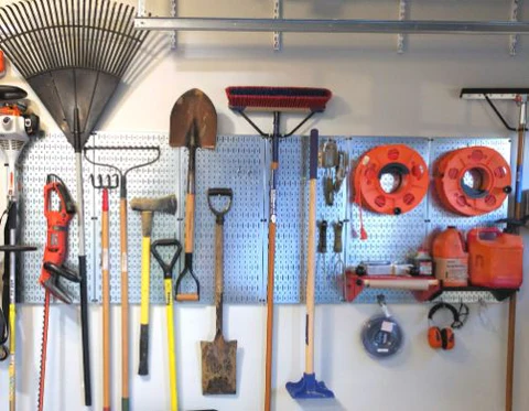 Garden tools stored on wall hooks at waist height