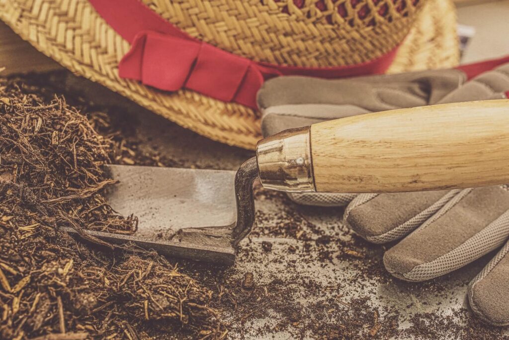 Mixing soil and compost in a container with a garden trowel
