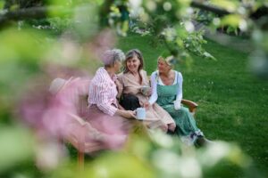Senior relaxing on garden bench after working with arthritis-friendly tools